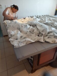 Leanne prepping sides for hemming.